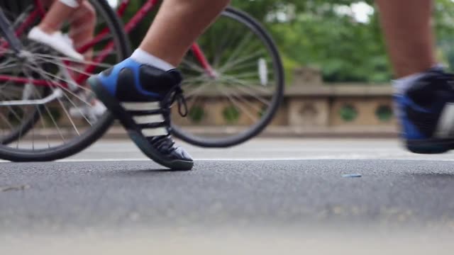 Dynamic video showcasing cyclists and pedestrians on a scenic park path.