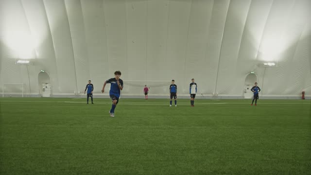 Energetic indoor soccer game showcasing teamwork and action.