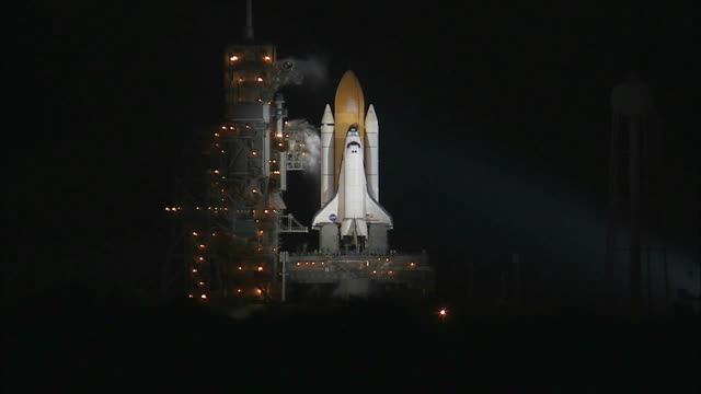Captivating night launch of a space shuttle with fiery liftoff.