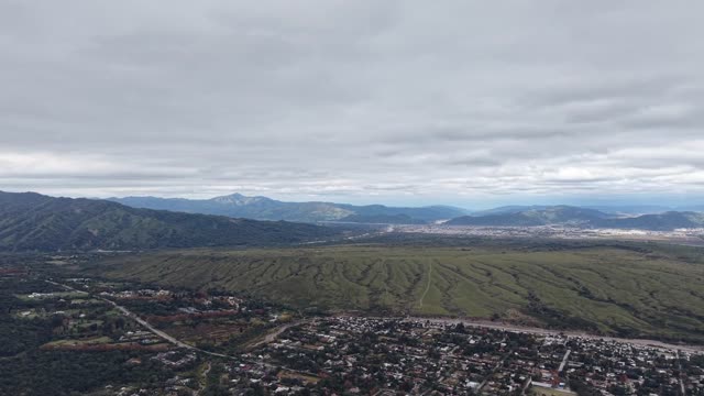Majestic aerial views of a vast landscape beneath cloudy skies.