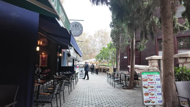 Explore a serene alley with cozy cafes and scenic architecture in Istanbul.