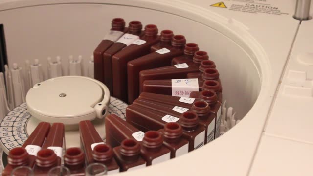 Close-up of a centrifuge processing samples in a laboratory setting.