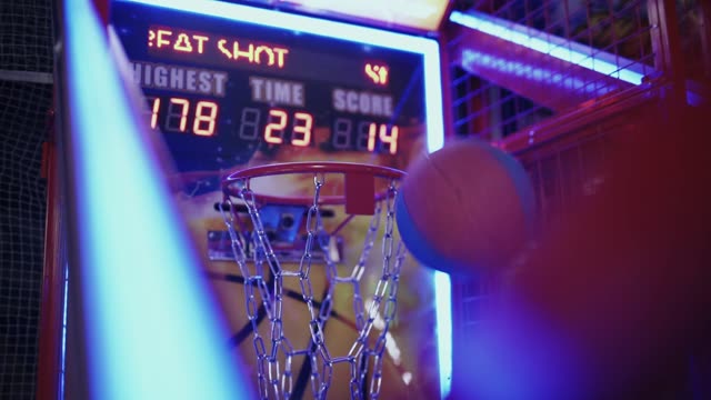 Experience the thrill of indoor basketball with neon lights and fast-paced action.