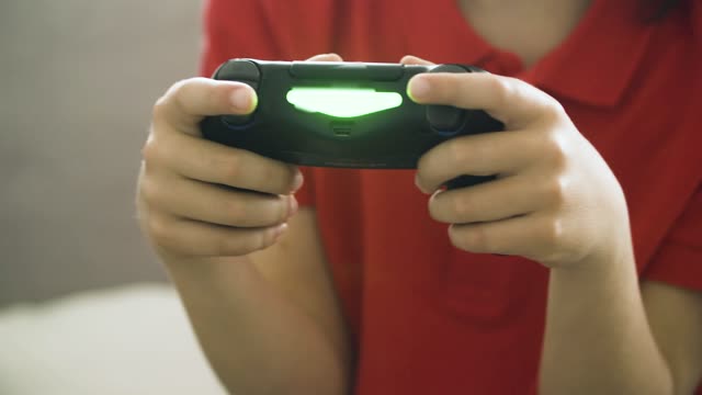 Two kids having fun playing video games together indoors.