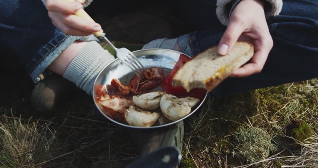 Woman enjoying a picnic with homemade sandwiches by a scenic lake.
