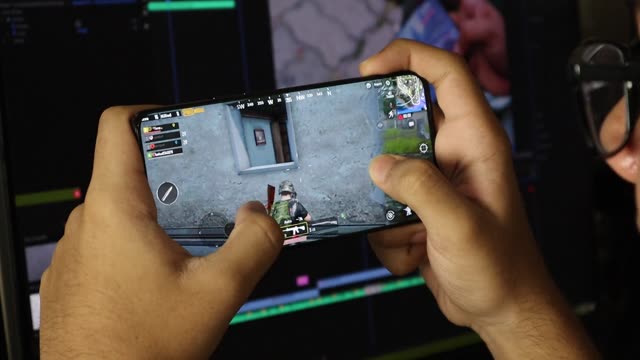 Close-up of a person playing a mobile game with engaging focus.