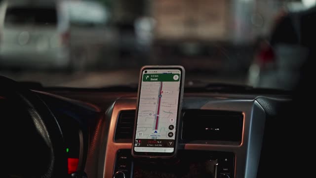 Close-up of GPS navigation app inside car during city traffic.