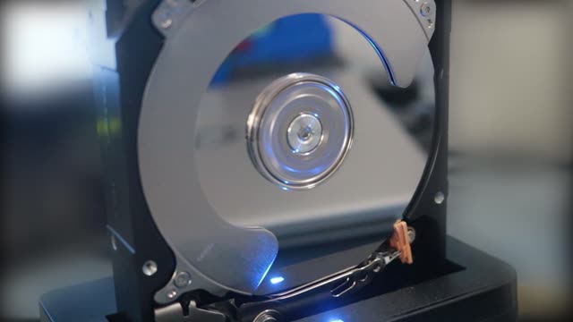 A detailed view of a hard disk drive spinning, illustrating modern technology operation.