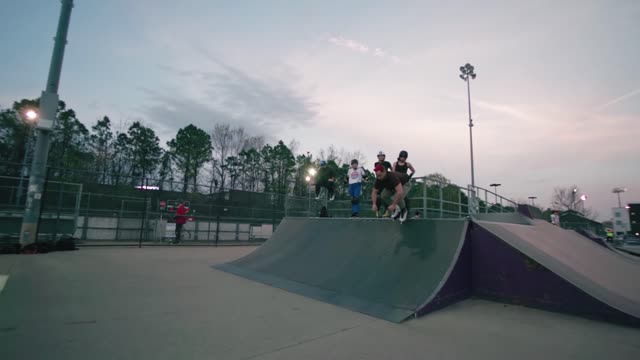 Experience high-energy rollerblading action and tricks at an outdoor skate park.