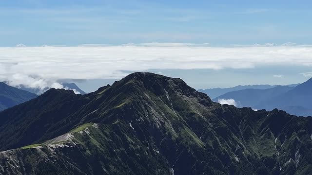 A breathtaking view of a rugged mountain range under a clear blue sky, perfect for nature enthusiasts.