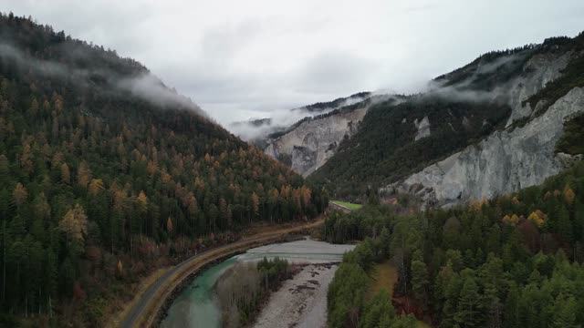 Drone footage of a picturesque foggy mountain valley in autumn.