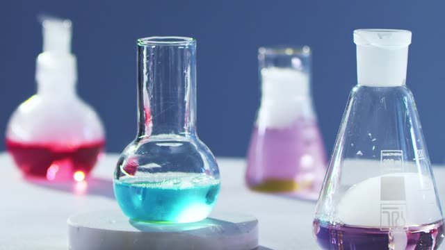Close-up of colorful chemical reactions in laboratory flasks